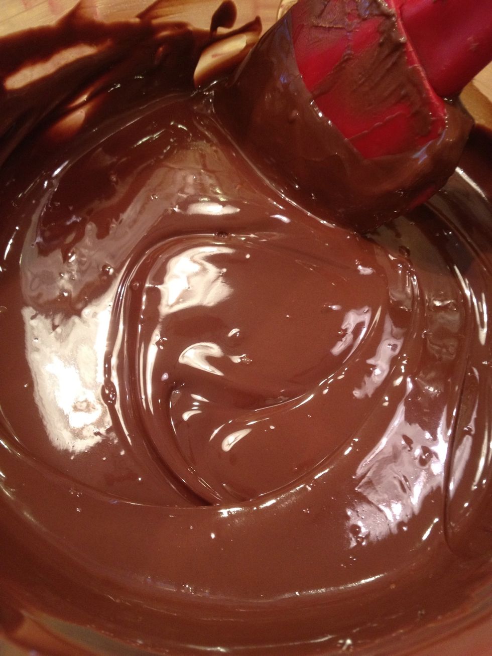 Melt the chocolate with a double boiler or in the microwave, either one works. Just keep an eye on it! If it's too thick, add a tablespoon of vegetable shortening to thin it out.
