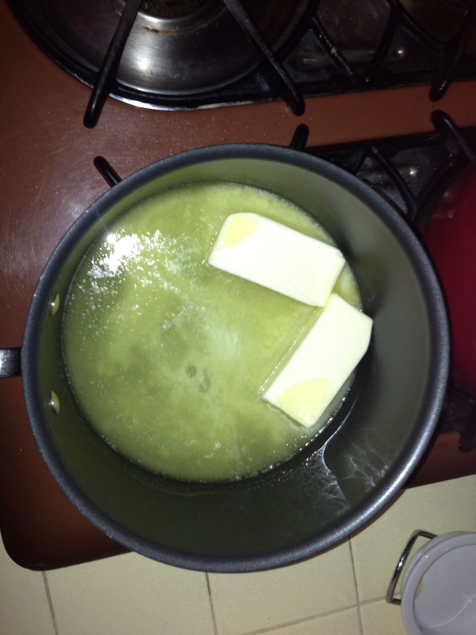 Melt the cup of butter in a large pot. Simmer on low.