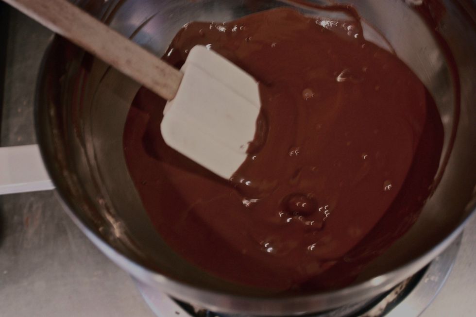 Melt the darker chocolate in a pan.