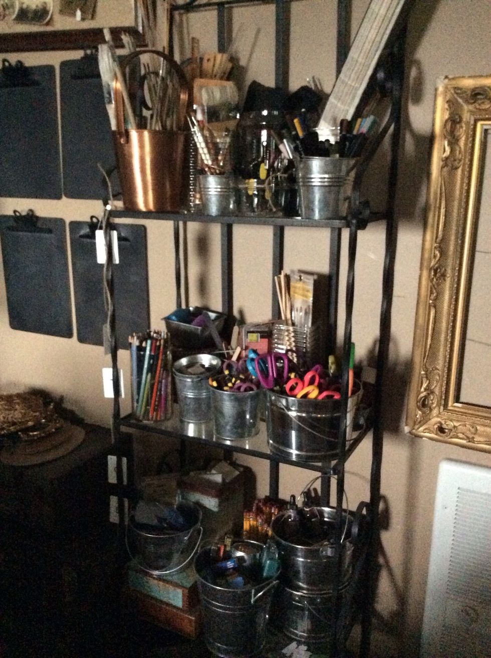 Metal bakers racks provide ample storage real estate, while taking up very little floor space. More metal buckets and tins keep items organized, handy and visual.