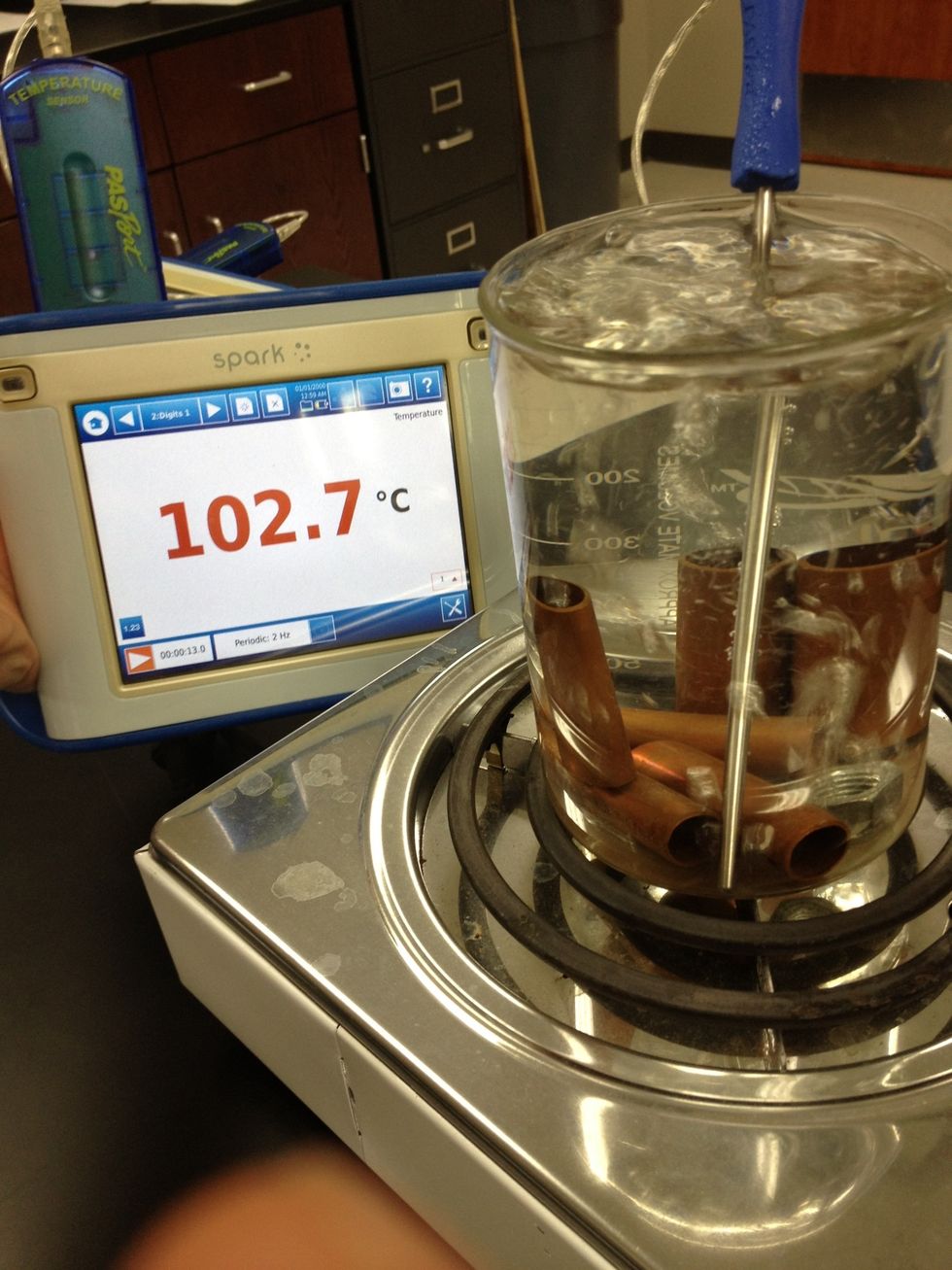 Metal is heated in hot water bath. Record the temperature of the hot metal. (it is the same as the hot water)