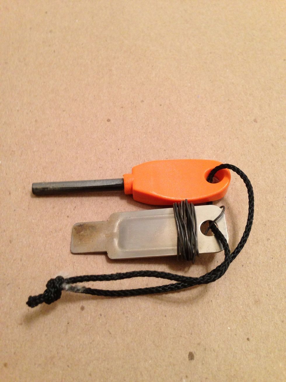 Metal match with steel striker. (Wire is wrapped around my striker $9.00 at REI)