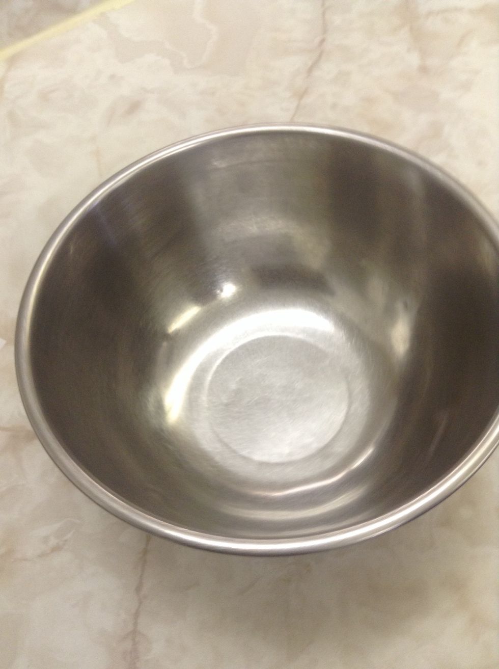Metal mixing bowl. Used to hold ingredients while mixing. I can use a metal mixing bowl to mix batter for a cake.