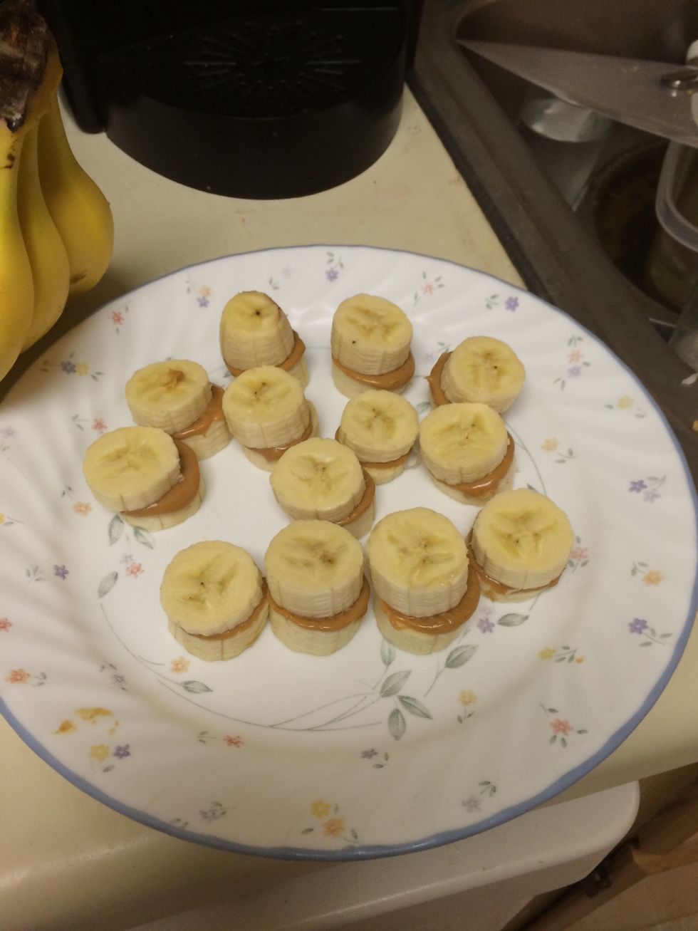 Microwave for 15 seconds! While warming honey & PB, cut bananas! Stir PB & honey! Use spoon and spread on banana slices and sandwich them! Then pop into the freezer until firm!