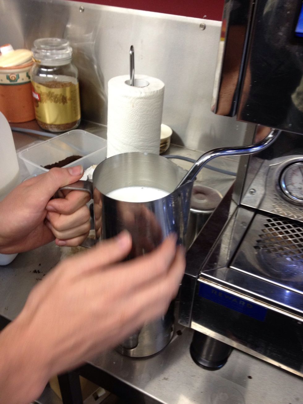 Milk should be heated to between 65 and seventy five degrees. If not using a thermometer this is about a count of three after the jug is too hot for fingers to hold.