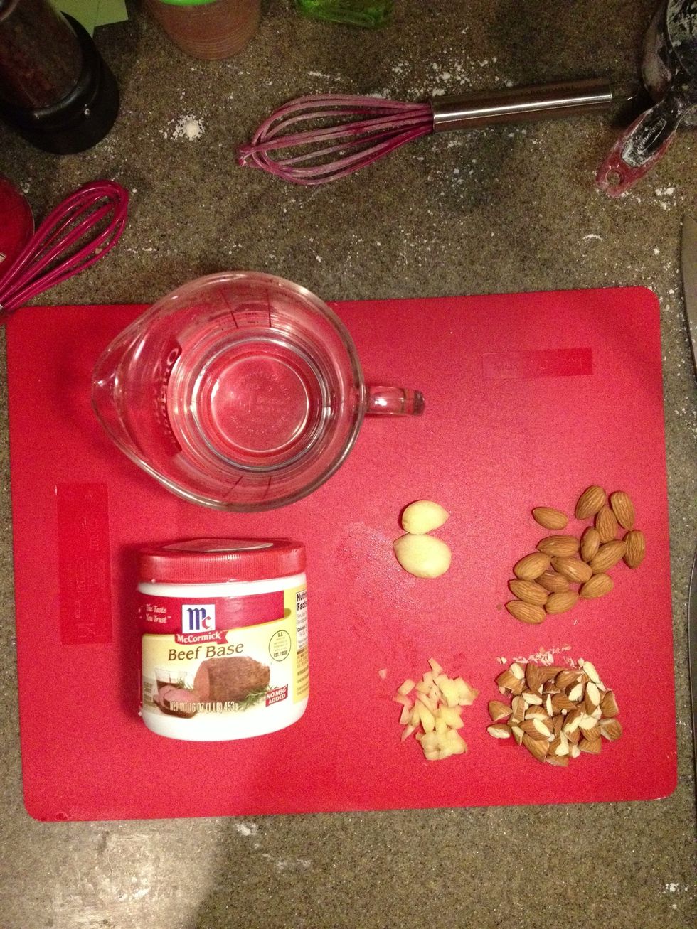 Mince 4 cloves garlic. Rough chop a handful of raw almonds. Prepare one cup of beef stock.