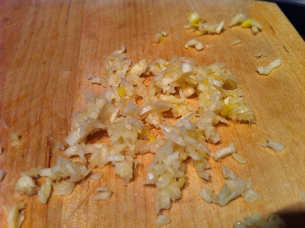 Mince garlic. Make these pieces as small as possible. Put aside.