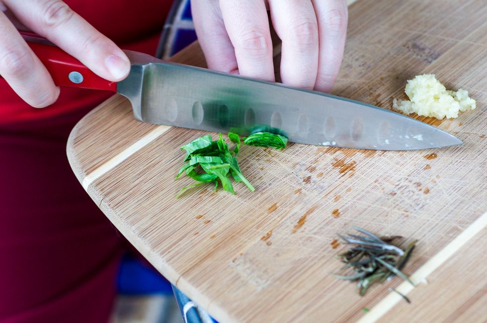 Mince the garlic and chop the basil, thyme and rosemary.