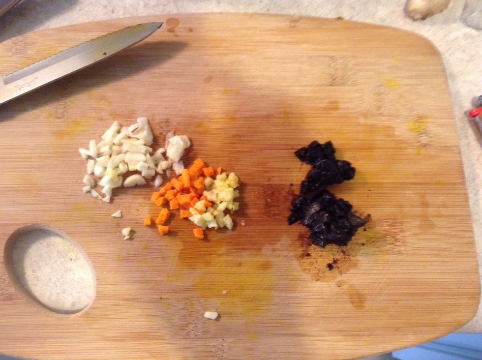 Mince the garlic, tumeric, and ginger. (use about 1" trimed round of tumeric and ginger). On the right there is the fermented garlic. it's a bit squishy but mince as best you can if you use it.