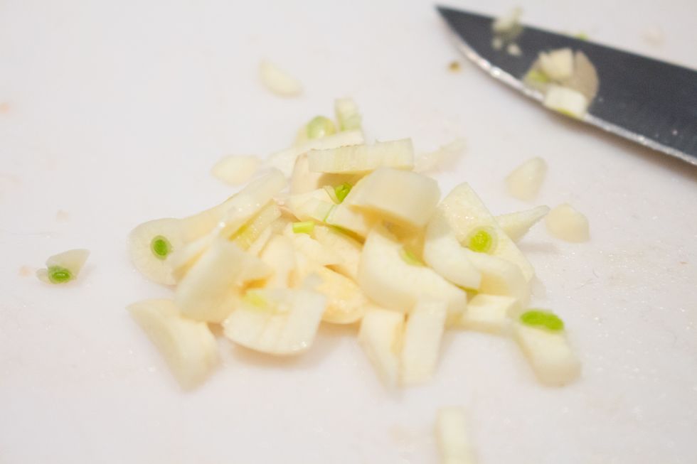 Mince two garlic cloves and toss into the crockpot