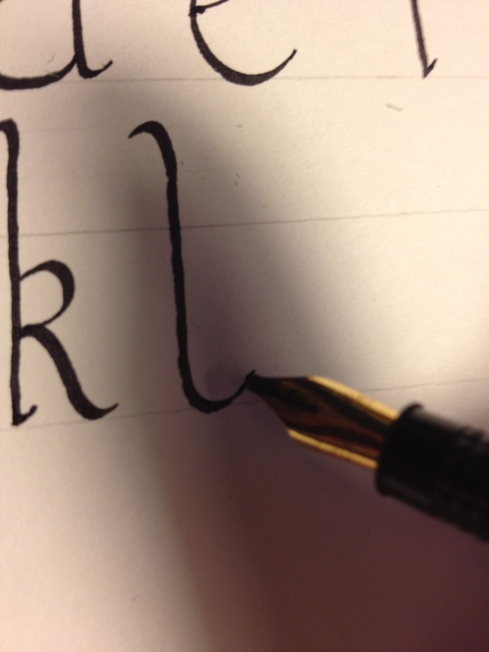 Minuscule "l" is perhaps the simplest letter to make; make a basic trunk, flaring up at the bottom to form a shallow cane.