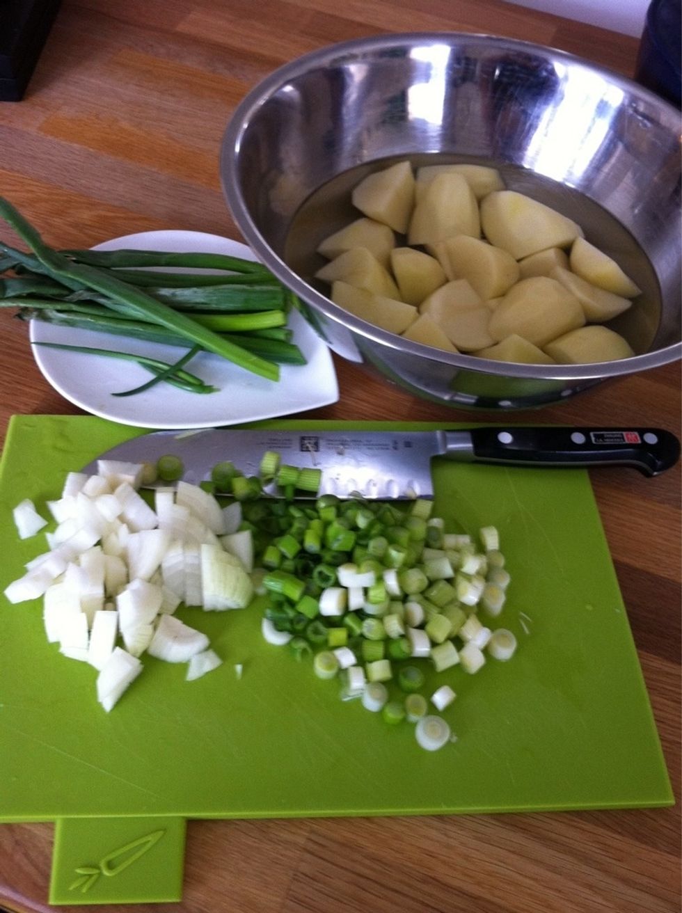 Mise en place: wash,peel and quarter potatoes; coarsely chop white onion and white part of spring onions