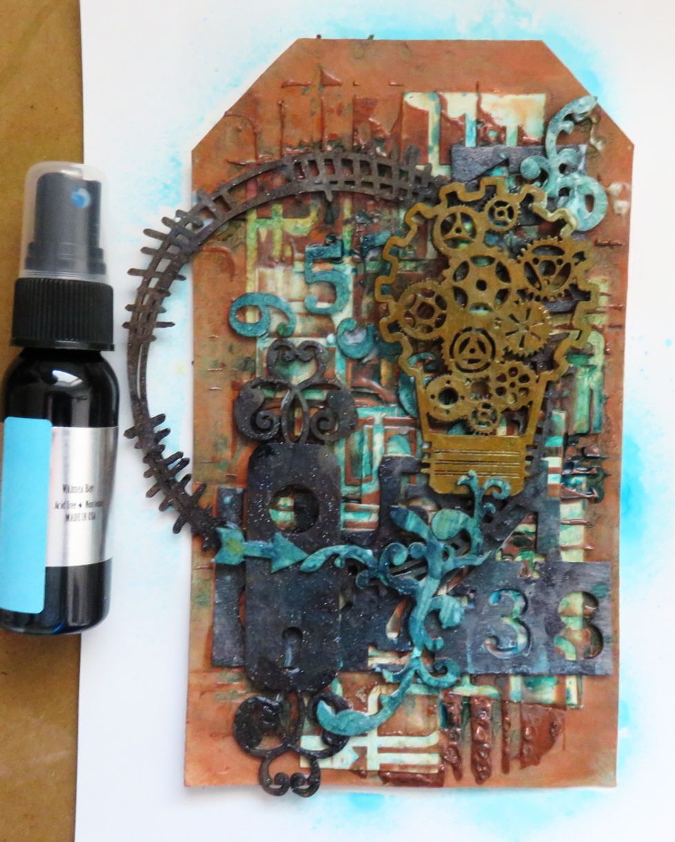 Mist the glued tag with Art Anthology Waimea Bay Colorations spray.