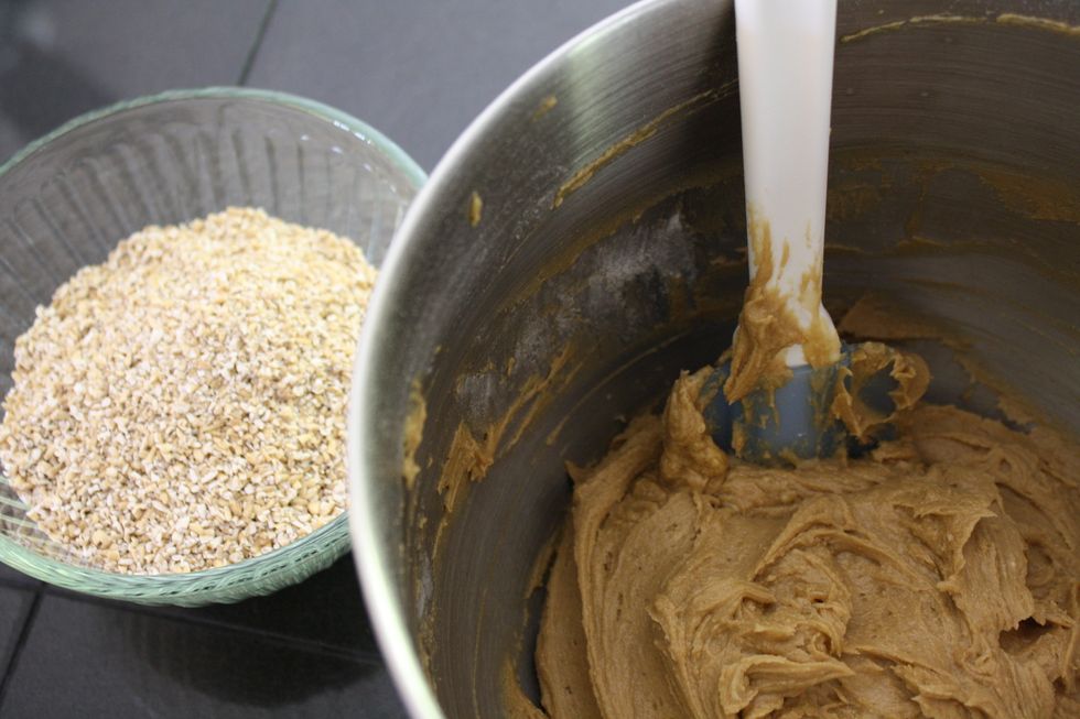 Mix 1 1/2 cups of quick cooking oats into the cookie dough by hand - a nice spatula should do the trick!