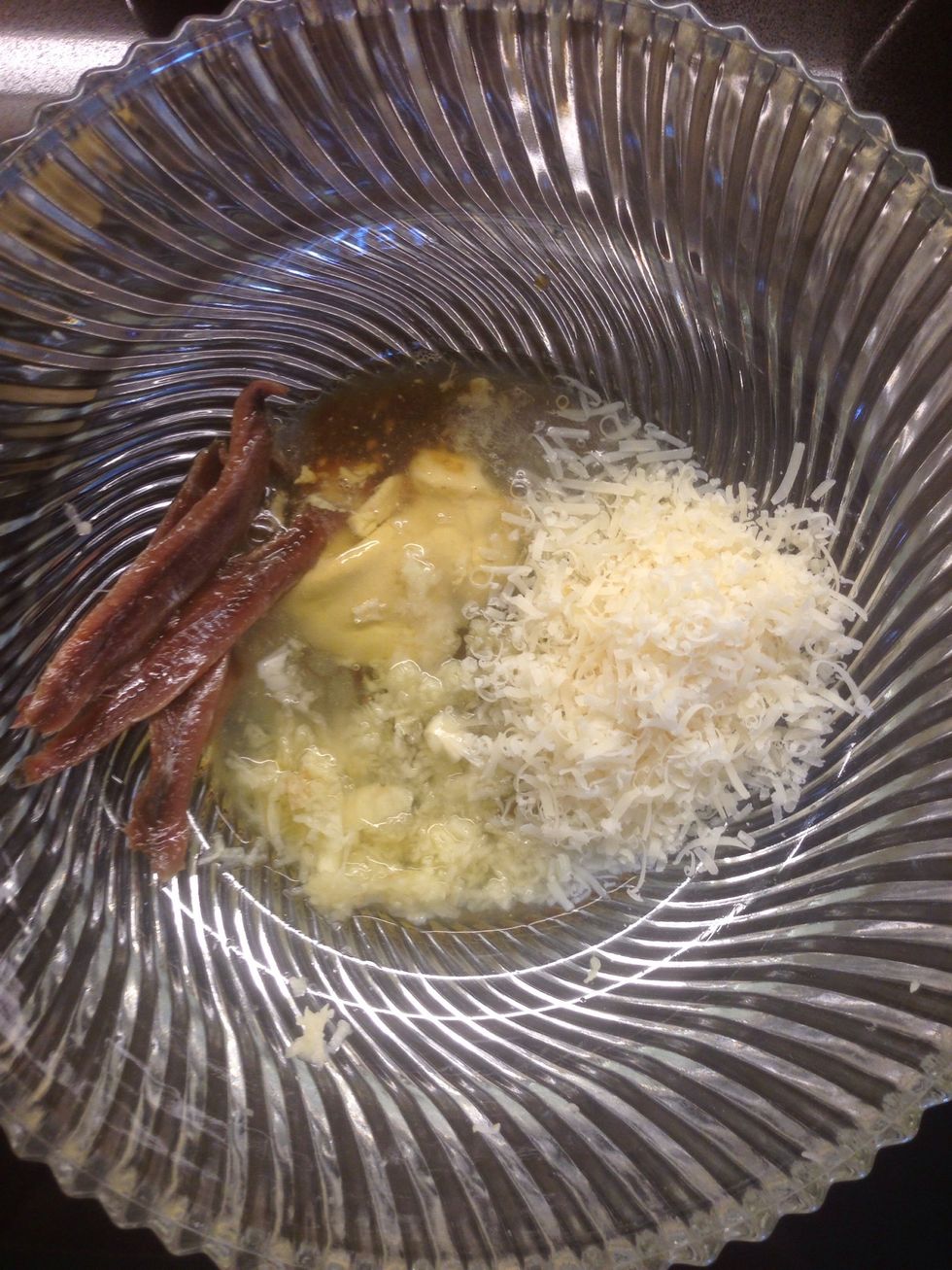 Mix 2 egg whites, 3 minced garlic cloves, 1 tbsp Dijon mustard, 1/4 cup shaved Parmesan cheese, 5 anchovy fillets, 2 tbsp lemon juice, 2 tsp Worcester sauce into a bowl