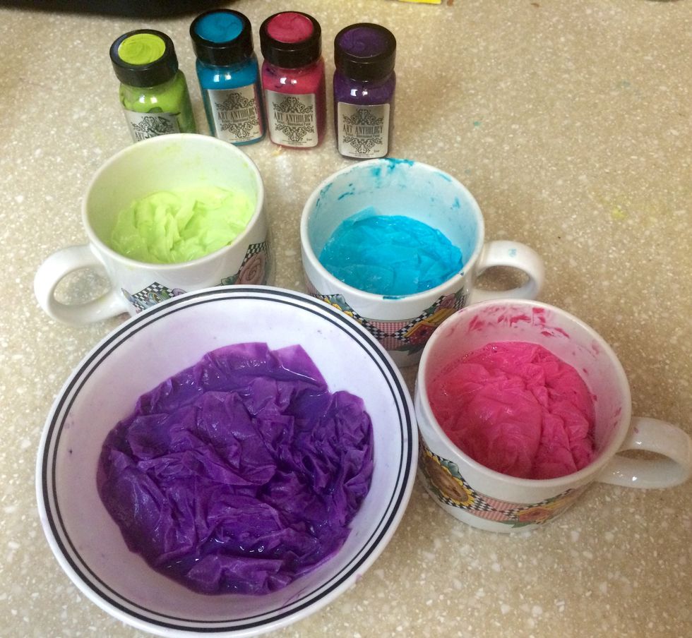 Mix 2 tsp of paint with 1/2 C water and add coffee filters. Separate them and smash them in there...let them soak for 2 hours then one by one squeeze out the excess water and lay them flat to dry.