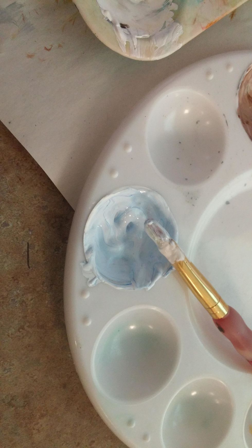 Mix a color for snow. Remember in a landscape the snow is not straight white, there's usually a blue tint to it. Mix a very little blue in with white.