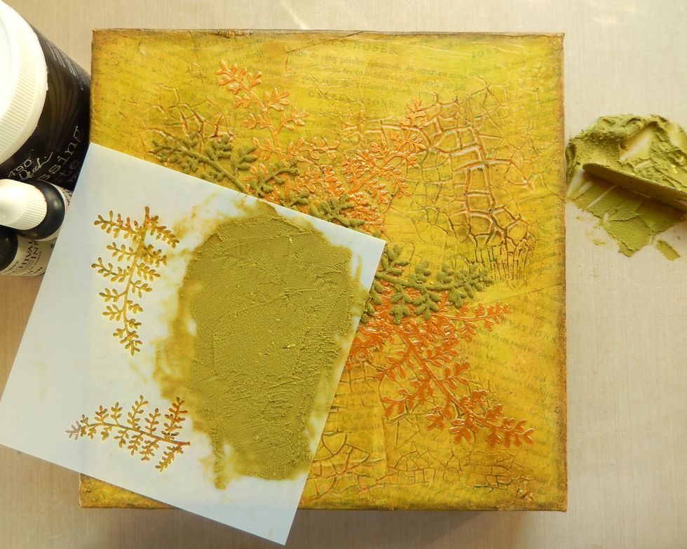 Mix a couple of drops of Fern Green Reinker and one of Potting Soil Reinker into some white embossing paste and mix thoroughly. Apply through the Ferns Stencil and allow to dry.