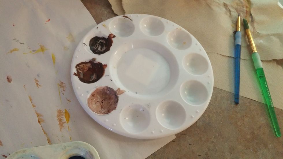 Mix a few browns for the tree trunks. It's a good idea to make a true brown and a shade and tint of that color. This way you can paint shadow and highlights.