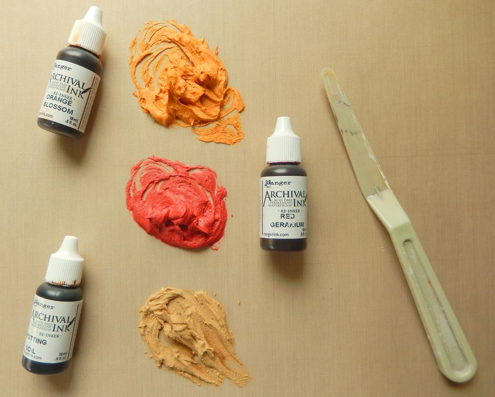 Mix a little of the white embossing paste with a drop of each of the Archival Reinkers.