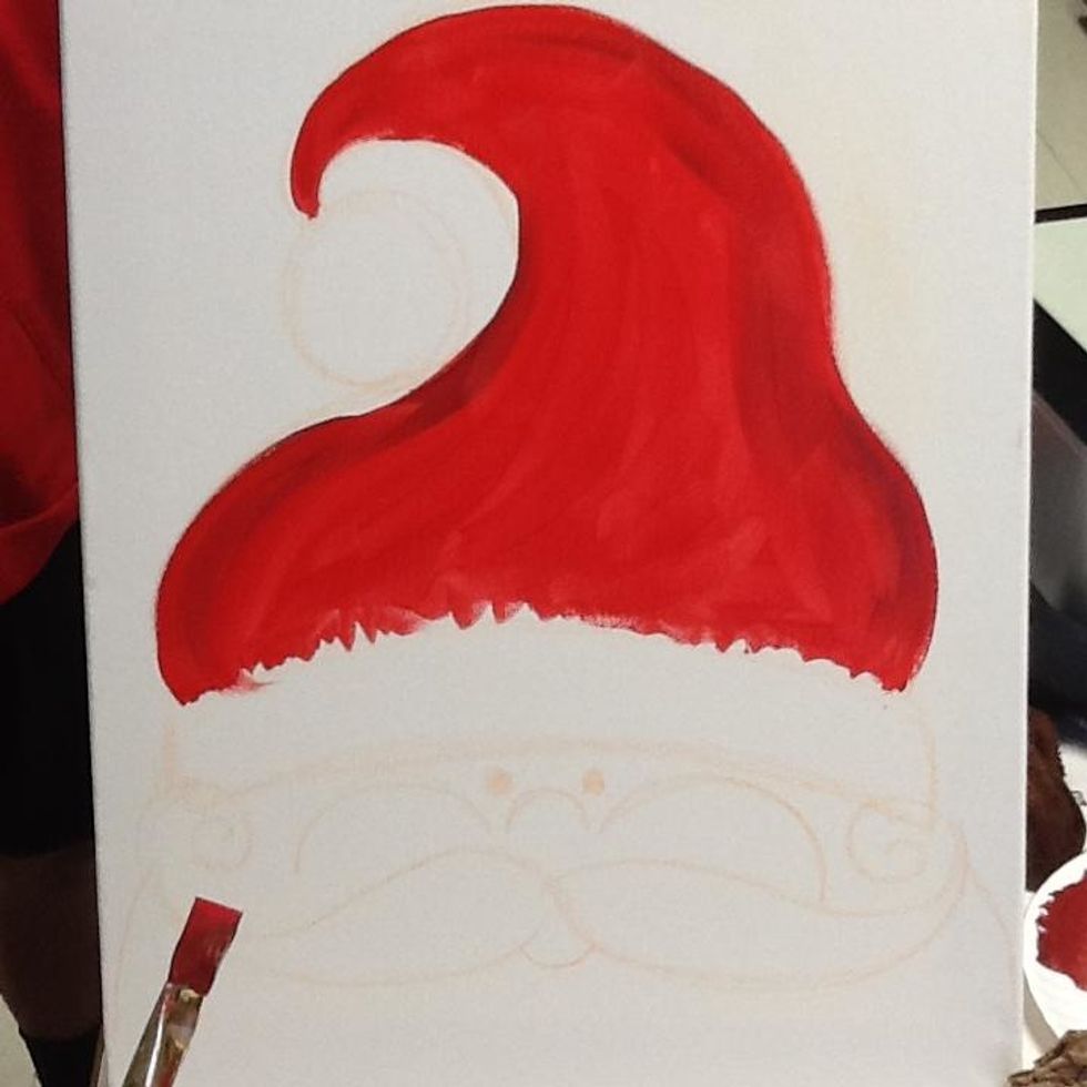 Mix a tiny amount of black with the red on the pallet and paint darker red around the outer edges of the cap.