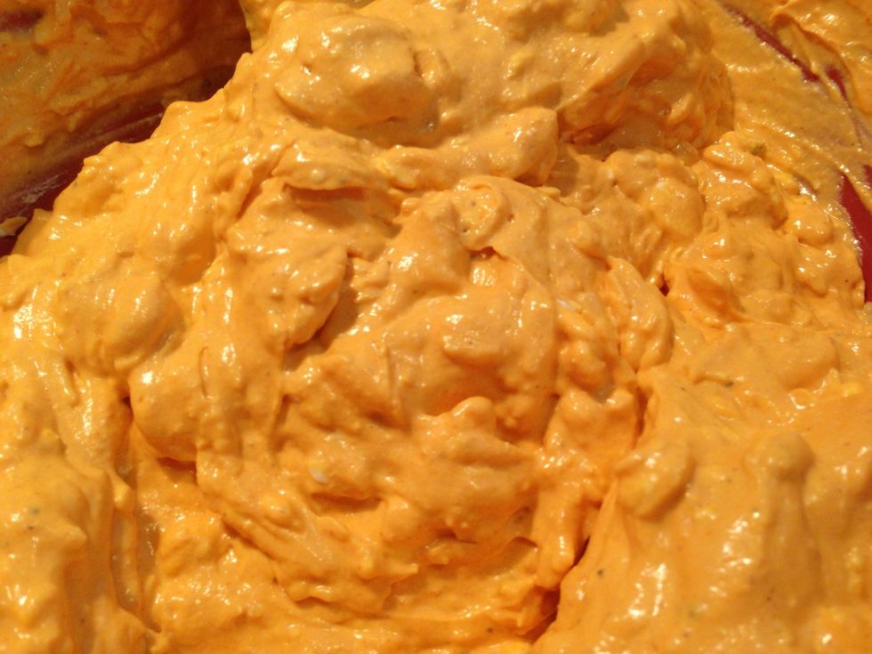 Mix all of the ingredients (except the chicken, and a handful of the pepper jack) in a large bowl. Stir until the mixture is smooth. (No big chunks). Taste and adjust the heat with the cayenne.