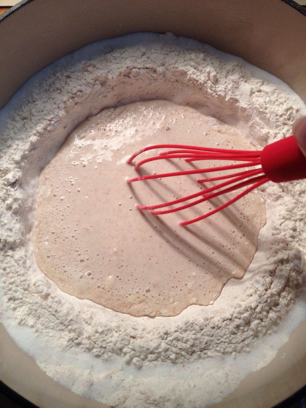 Mix all the flour in a large bowl, leaving a dent in the middle, then add the table salt to the edge of the flour. Add warm water, yeast and whisk about a third of the flour with the water.