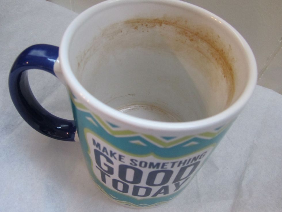 Mix baking soda and a little bit of water (just enough to make a paste-like consistency) in your mug and scrub all the stains away with your finger.