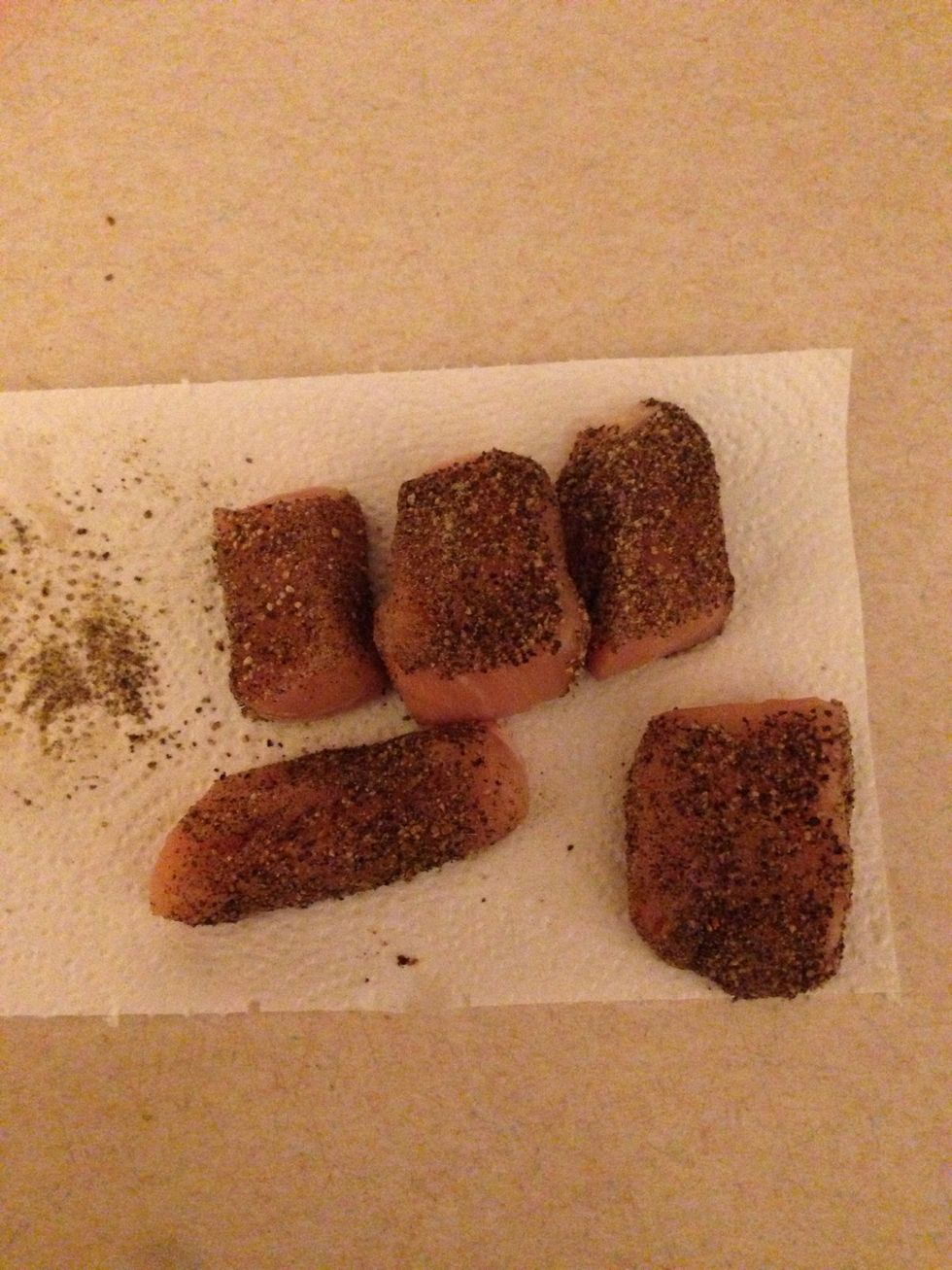 Mix black pepper with salt and roll the chicken in the mixture until its covered