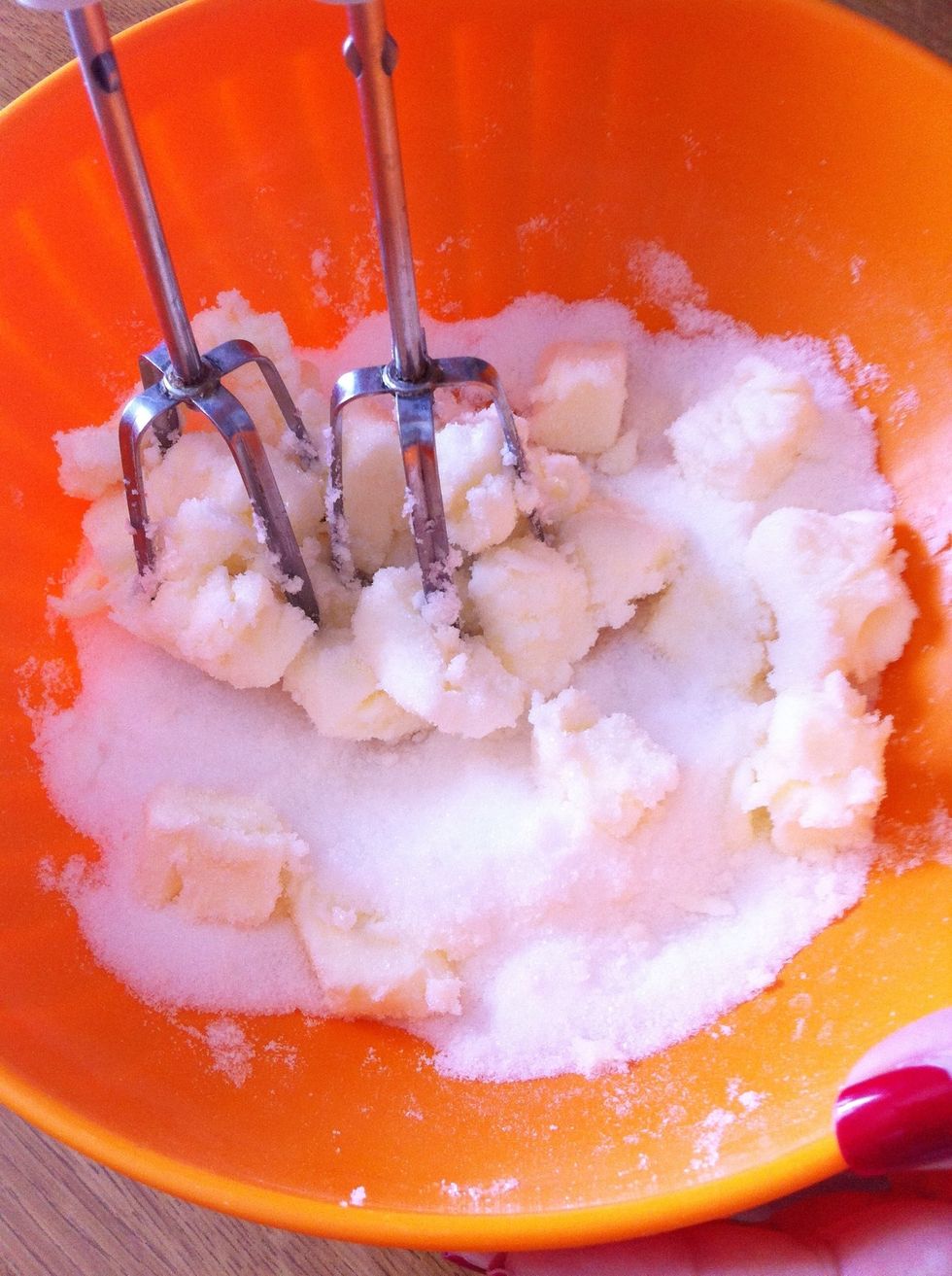 Mix butter and sugar together in a large bowl until creamy