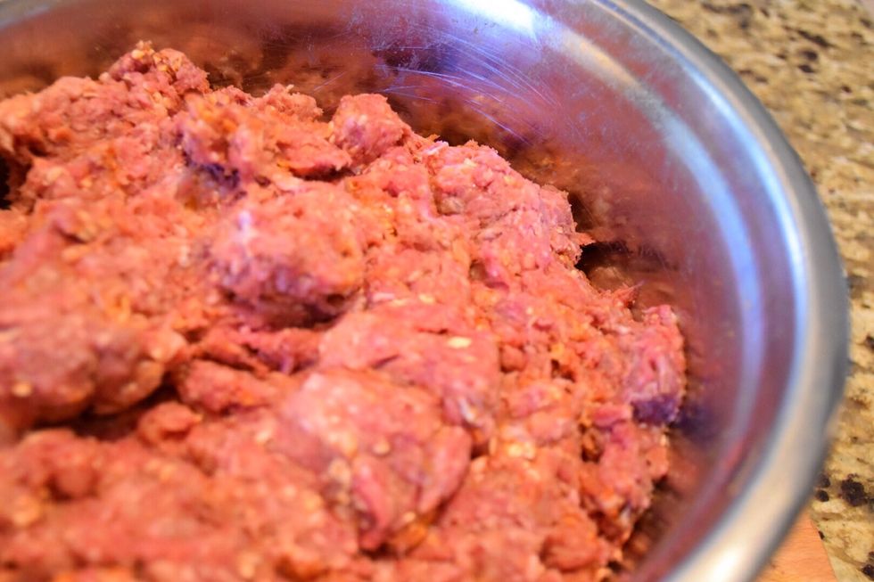 Mix by hand ( I wear latex gloves to do so). Don't overwork the meat. Mix until spices and oats are uniform throughout the mixture.