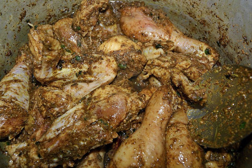 Mix everything around. Make sure all the chicken gets coated with the curry mixture. Let it cook for a bit. Observe the color change. Meat should start getting darker.