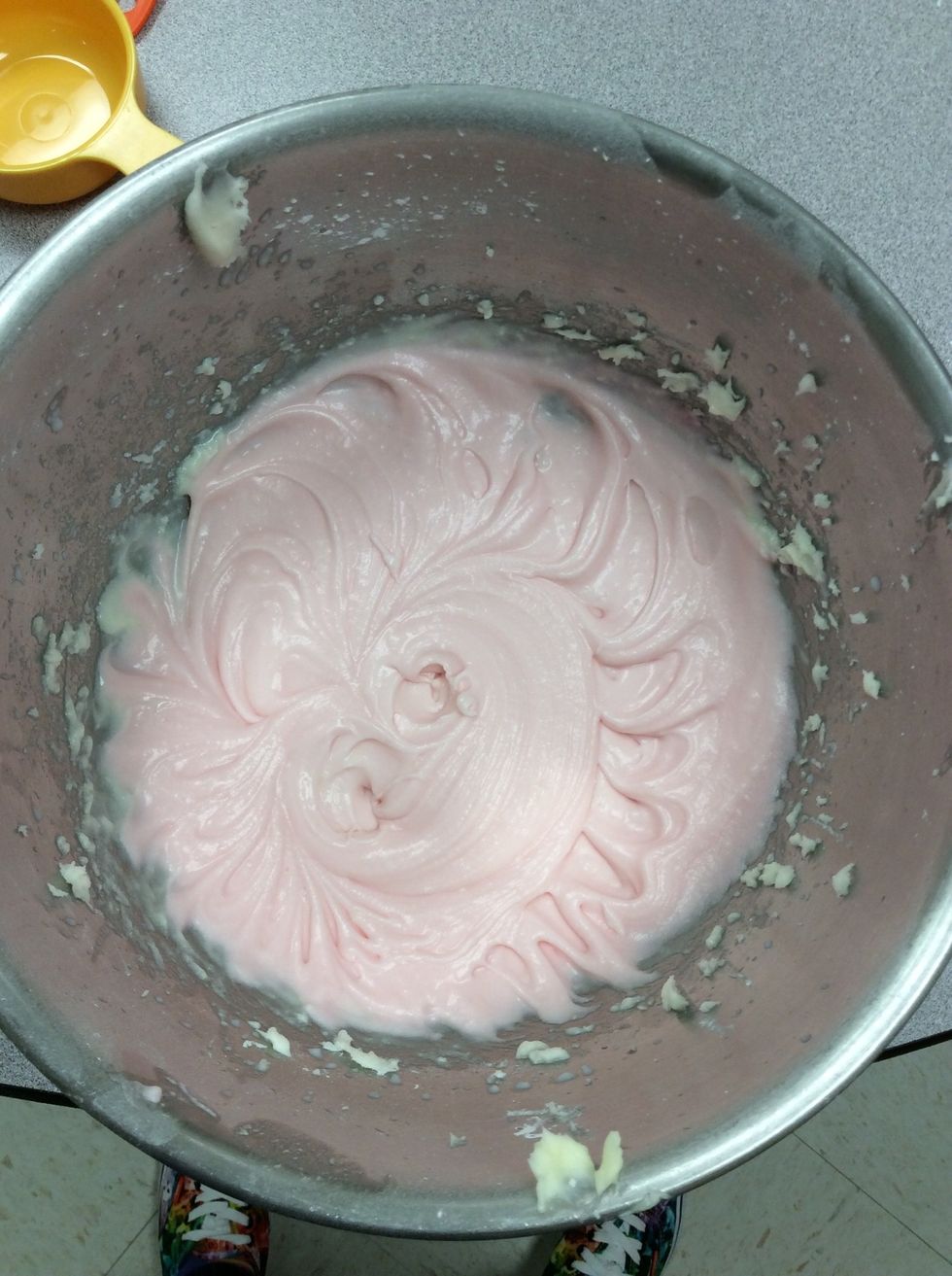 Mix frosting ingredients until smooth: powdered sugar, butter, while milk, salt, pink lemonade, lemon extract and food coloring.