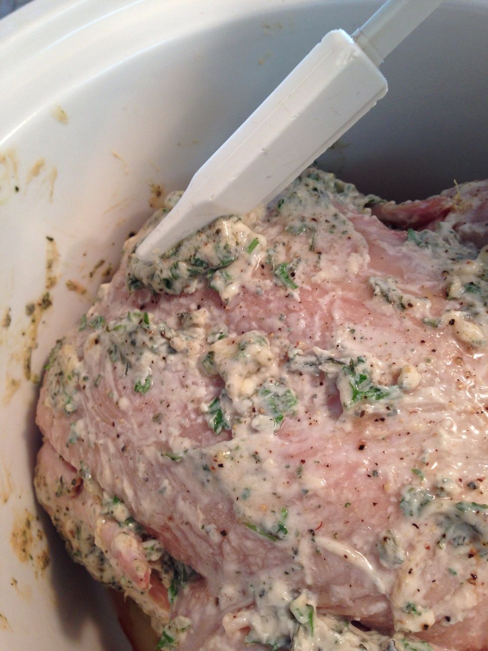 Mix herbs, butter, etc, forming a paste. Spread onto bottom of chicken before placing it into slow cooker. Spread remainder on top.