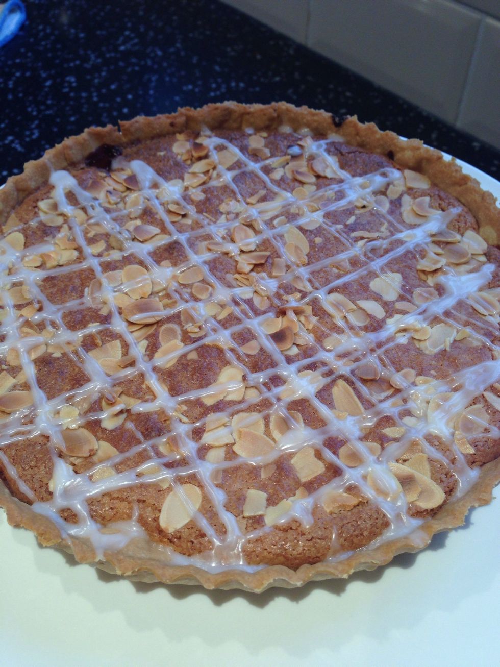 Mix icing sugar and a little water to make some water icing. Then pipe over the tart in a zig zag pattern