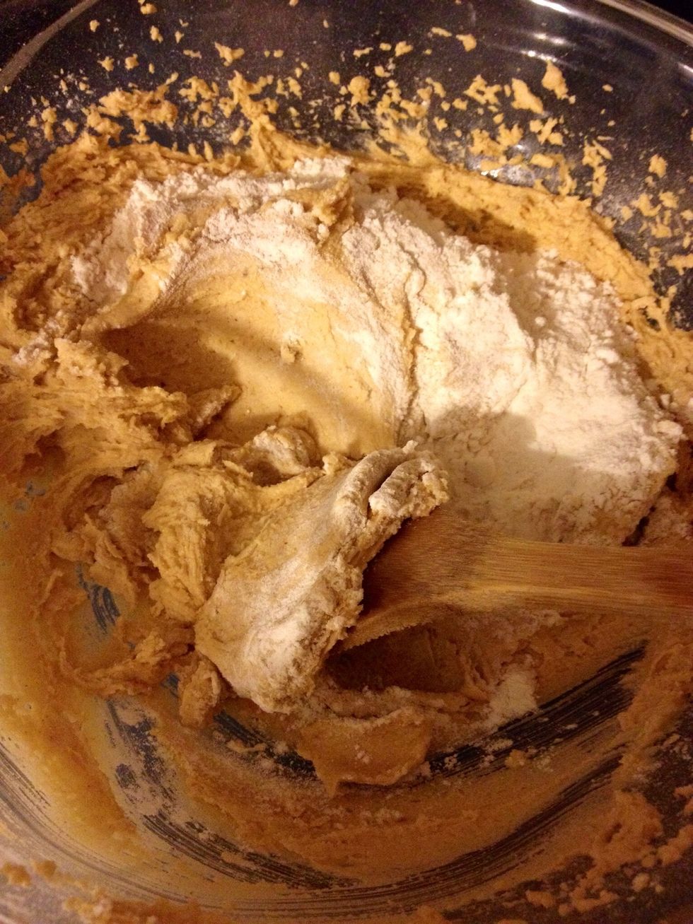 Mix in as much flour as you can (my mixer manhandled about 3/4 cup). Use a wooden spoon to mix the remainder by hand. Total of 1 and 1/4 cups of the white stuff.