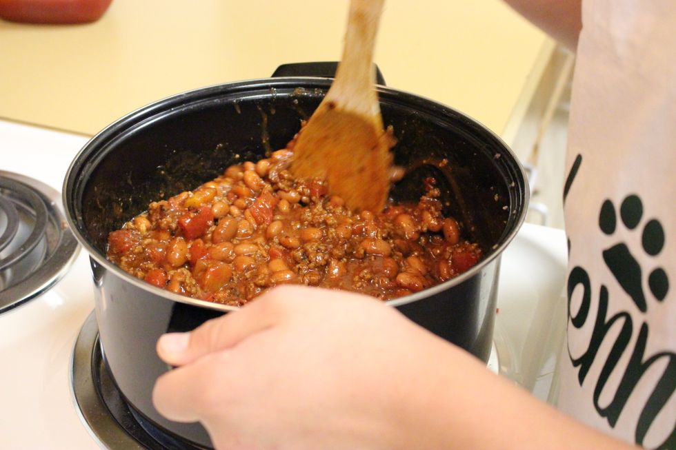 Mix in can of Ranch Style Beans. Do not drain them first. Continue stirring until all ingredients are hot. Turn down heat and simmer for 15 minutes.