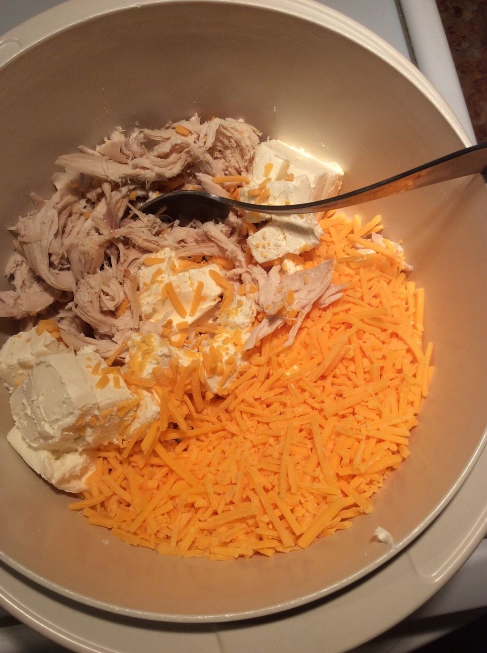 Mix in the cubes of cream cheese and regular cheese.