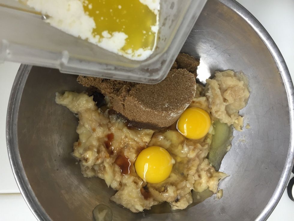 Mix in the eggs, brown sugar, vanilla, and melted butter to the bananas.
