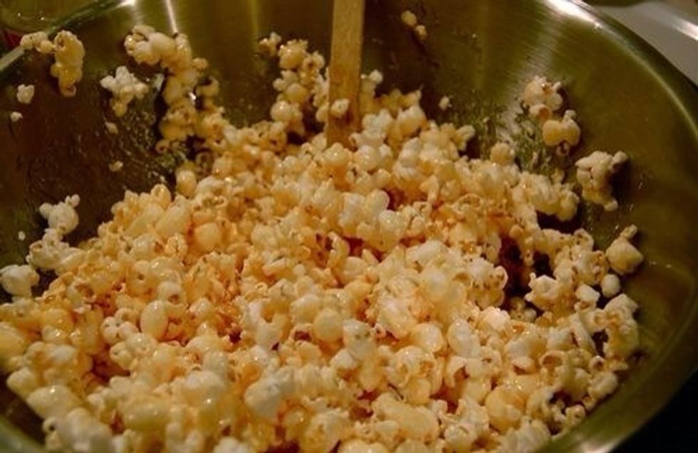 Mix in with the popcorn. I put butter in my hands to help mix it together. The butter helps your hands not get too sticky