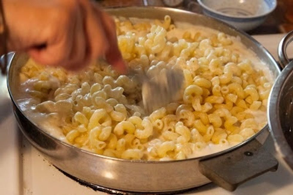 Mix it together well until it's nice and smooth, then add in the pasta. Stir everything together.