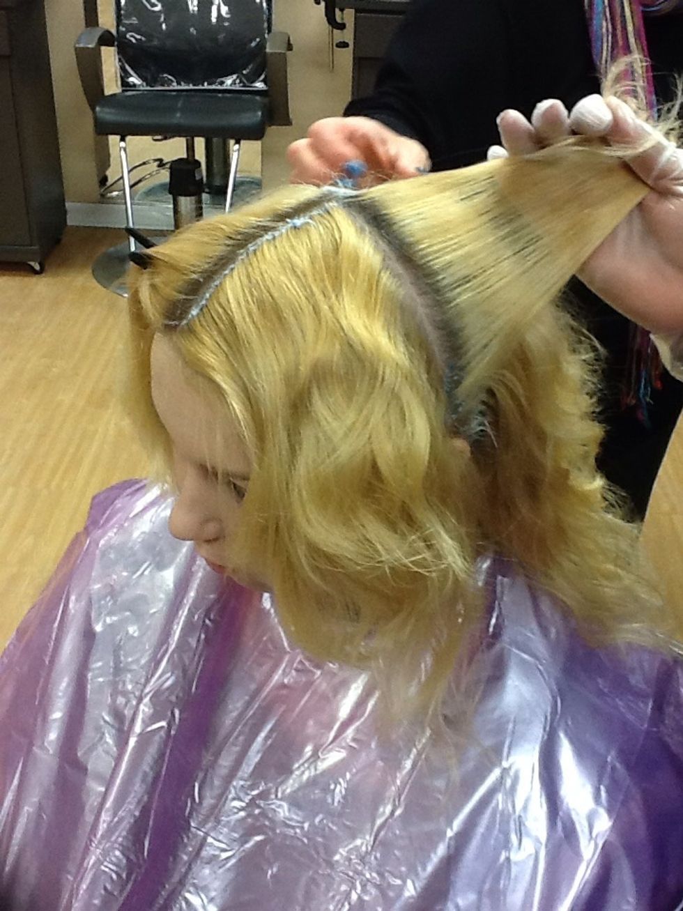 Mix lightener product and section clients hair into 4-sections. Make 1/4" partings and apply lightener to new growth ONLY.