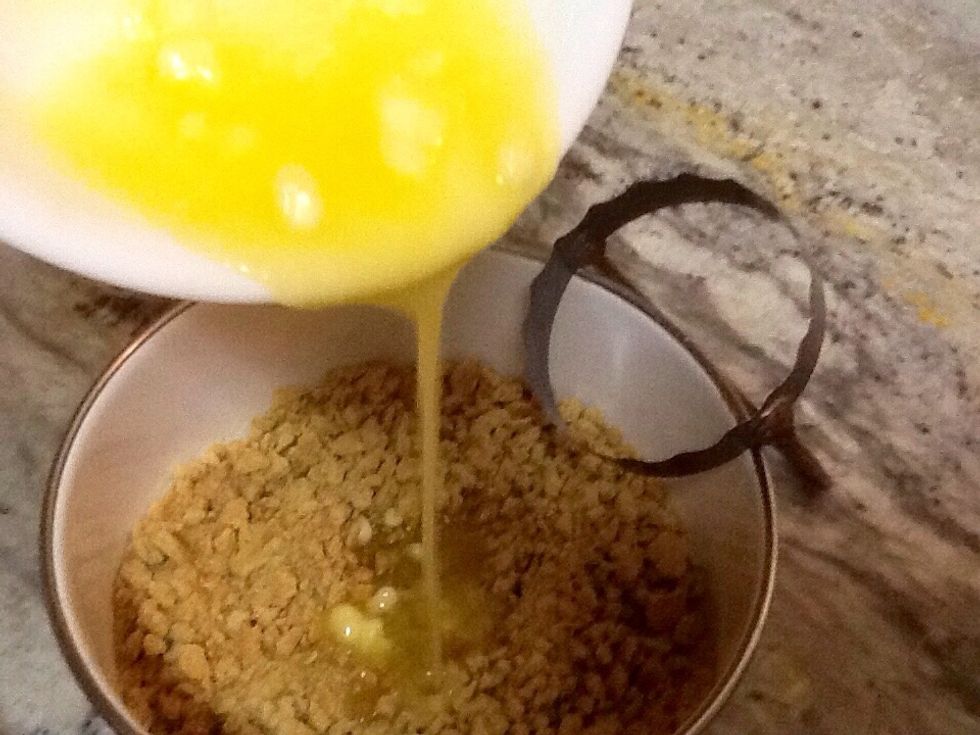 Mix melted butter with crushed graham crackers.  Sprinkle mixture in 9x13 pan that is lined with parchment paper. The parchment paper is the real secret ingredient, don't leave it out!