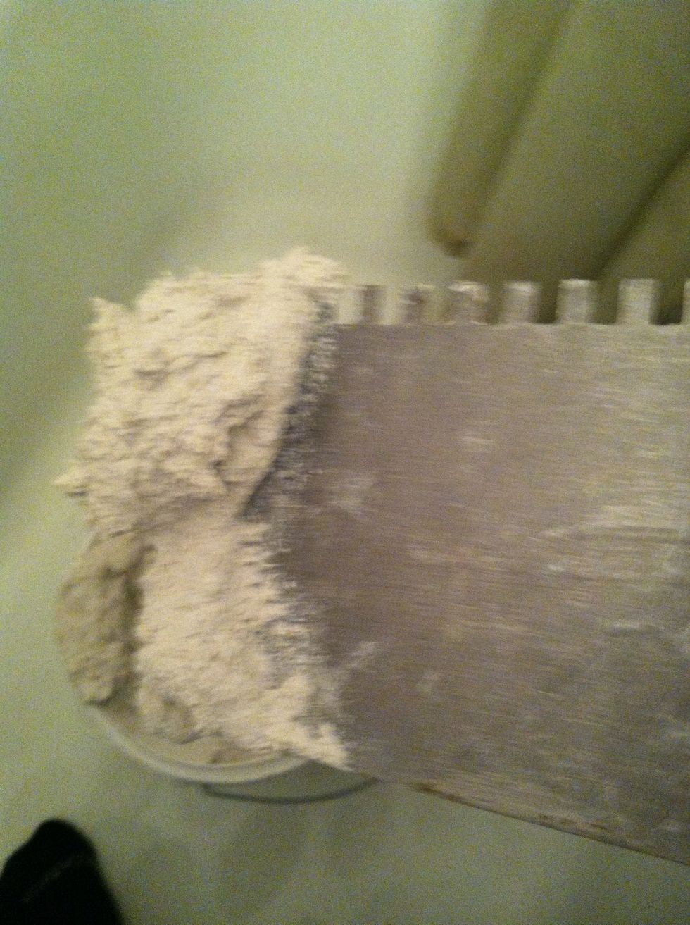 Mix mortar in bucket (or use premixed thinset as I did) and place some mortar on flat edge