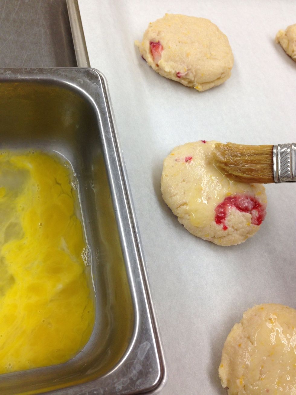 Mix one egg in a separate bowl and brush tops generously.