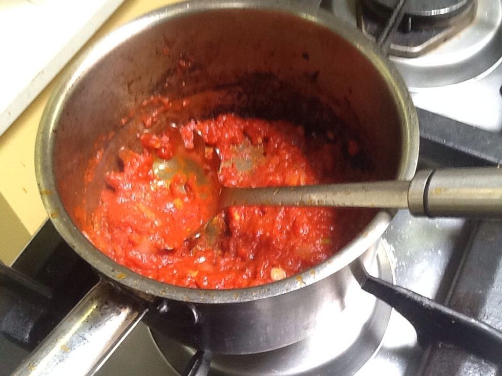 Mix onion,garlic,oregano and the tinned tomatoes in a oiled pot on medium heat till onion is browned and sauce is at the desired consistency. This should take 7-15 minutes.