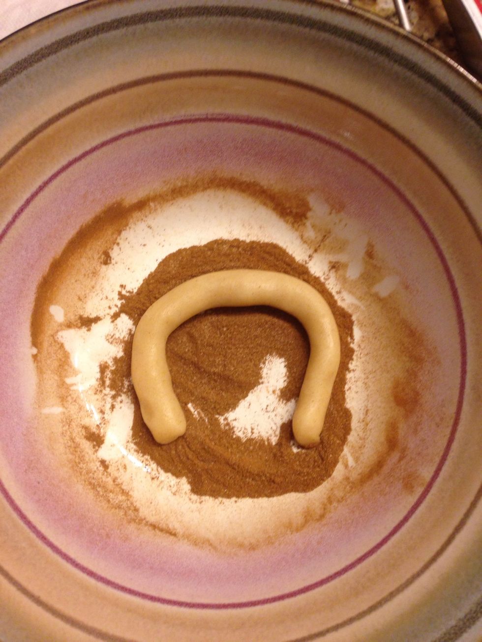 Mix some cinnamon and sugar in a bowl (I'm sorry I didn't measure this out, it's about two parts cinnamon to one part sugar) and dip one side of the rope into the mix.