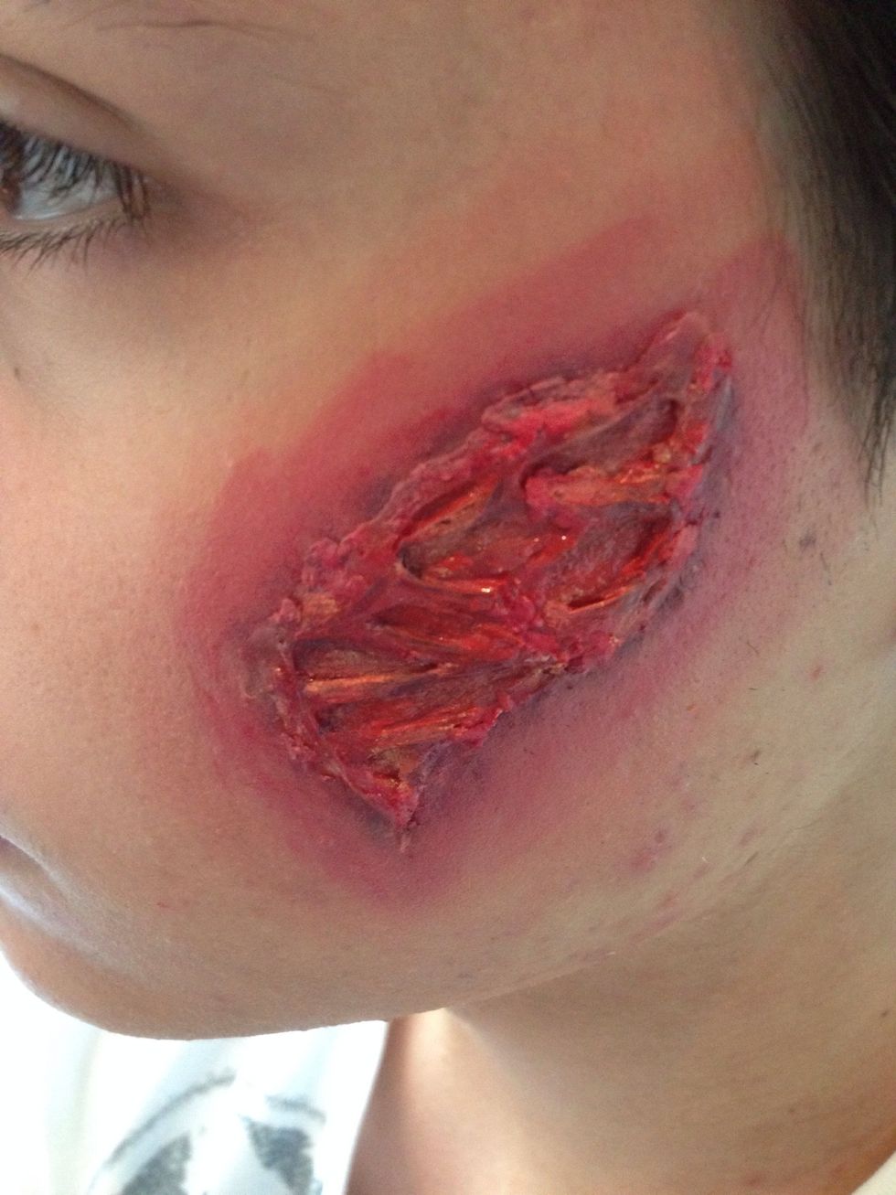 Mix some foundation with the cream blush and apply around the wound