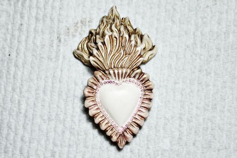 Mix some magenta oil pastel with a watercolor brush and color the detail around the outside of the heart, then wipe off excess. This will allow the small circle details to pop.