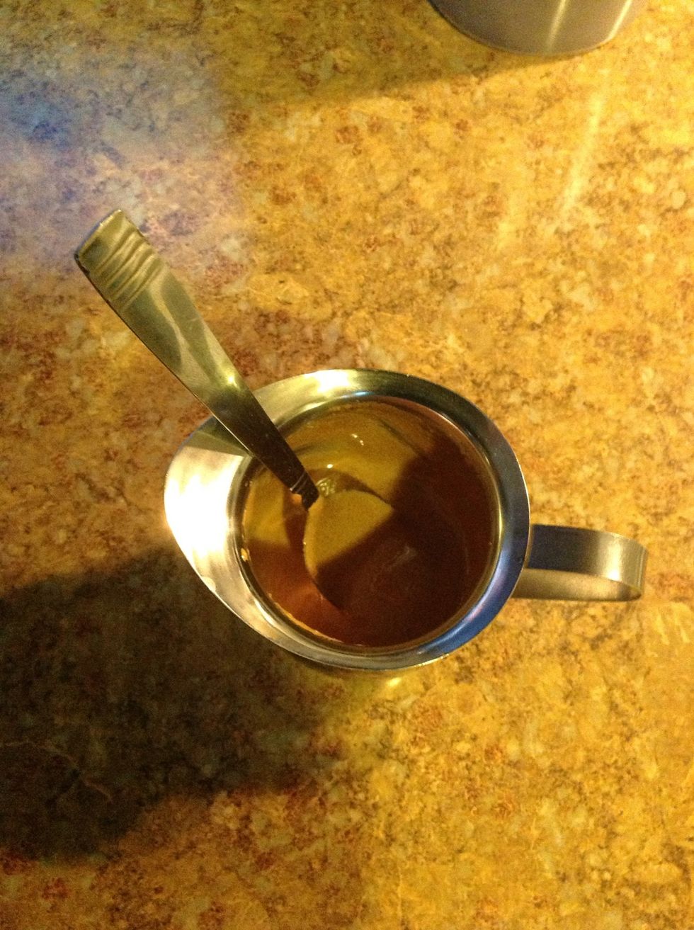 Mix sugar vigorously with about a teaspoon of coffee into the cup until you have a caramel color mixture.